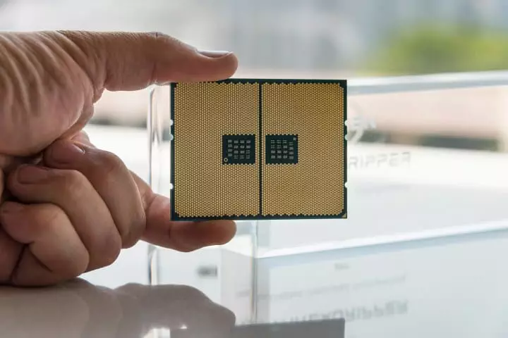 A person holding an AMD Ryzen Threadripper 1950X.